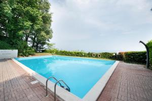 a large swimming pool with blue water at vista lago apartment 2 in Soiano del Lago