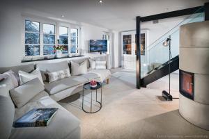 a living room with a couch and a tv at Fachwerkhaus Eiben in Kirchhundem
