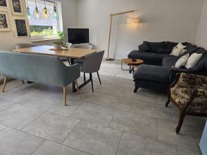 a living room with a table and a couch at Haus Alb-Apfel in Apfelstetten