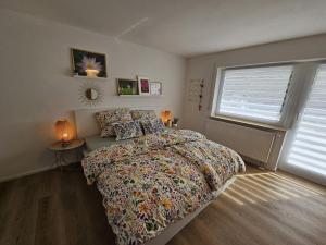 a bedroom with a large bed and a window at Haus Alb-Apfel in Apfelstetten