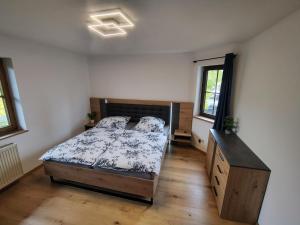 a bedroom with a bed and a dresser in it at Ferienwohnungen Leiteritz in Königsfeld im Schwarzwald
