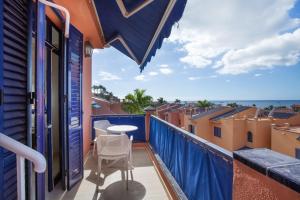 a balcony with a table and a view of the ocean at Bahia Meloneras Luxury Duplex in Maspalomas