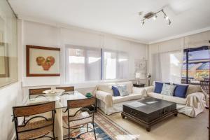 a living room with a couch and a table at Bahia Meloneras Luxury Duplex in Maspalomas