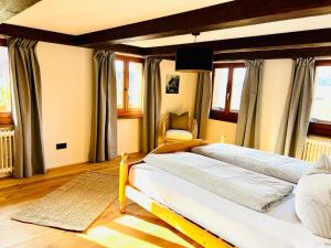 a bedroom with a large bed and a chair at Hof Wälderblick in Ibach