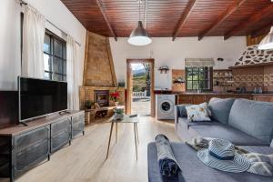 a living room with a couch and a tv at Finca Viña Maria in Los Realejos