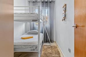 a bunk bed in a room with a ladder at Malvarrosa A103 in Fuengirola +13 photos