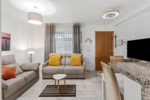a living room with a couch and a table at Malvarrosa A103 in Fuengirola