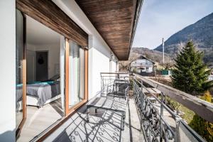 a balcony with a view of a bedroom and mountains at Villa L'Oranaise in Cluses