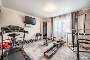 a gym with several exercise equipment in a room at Villa L'Oranaise in Cluses