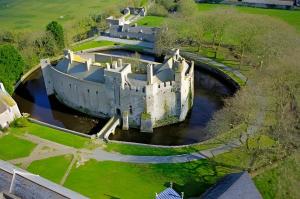 an aerial view of a castle in the water at L'hermitage, Villa Front De Mer in Pirou