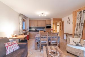 a living room with a couch and a table at App 6 pers cozy centre Samoëns in Samoëns