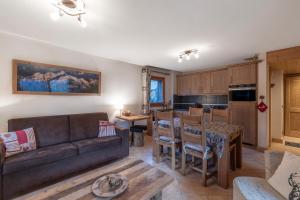 a living room with a couch and a table at App 6 pers cozy centre Samoëns in Samoëns