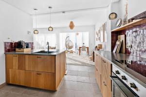 a kitchen with wooden cabinets and a counter top at Casa Maria Luisa in Manilva
