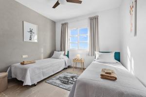 a bedroom with two beds and a window at Casa Maria Luisa in Manilva +36 photos