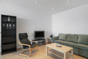 a living room with a couch and a tv at Casa Boliches32 in Arcos de la Frontera