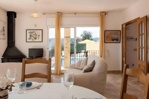 a living room with a couch and a table with wine glasses at Villa Granvista by Easy Brava in Calonge