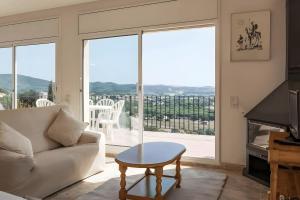 a living room with a couch and a table at Villa Granvista by Easy Brava in Calonge