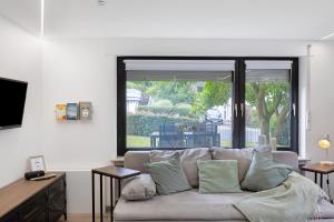 a living room with a couch and a large window at Fewo Goldbach in Eschwege