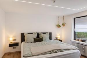 a bedroom with a large bed and a window at Fewo Goldbach in Eschwege