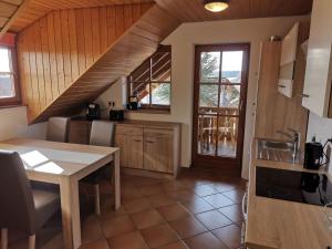 a kitchen with a table and a dining room at Ferienwohnungen Leiteritz in Königsfeld im Schwarzwald