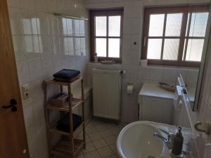 a bathroom with a tub and a sink at Ferienwohnungen Leiteritz in Königsfeld im Schwarzwald +29 photos