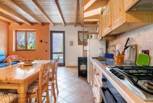 a kitchen with a wooden table and a dining room at Piantina Holiday Home in Sacco +18 photos