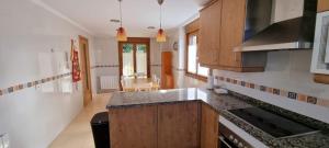 a kitchen with wooden cabinets and a counter top at Casa La Marina in Llanes