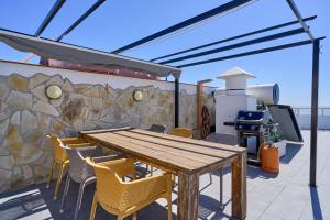 a wooden table and chairs on a patio at Atico Carabela By Ist in Torrox