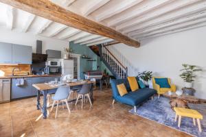 a kitchen and living room with a table and chairs at La clé des Champs in Couffy +18 photos