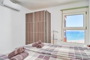 a bedroom with a large bed and a window at Atico Carabela By Ist in Torrox +28 photos