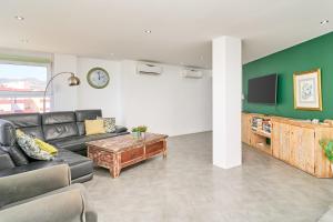 a living room with a couch and a tv at Atico Carabela By Ist in Torrox