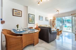 a living room with a couch and a table at Mi capricho Beachfront Apt in Mijas