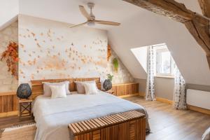 a bedroom with a large bed with birds on the wall at La clé des Champs in Couffy