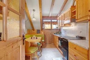 a kitchen with wooden cabinets and a table in it at Ebnichers Paradies in Cardano