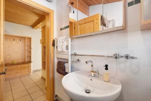 a bathroom with a sink and a mirror at Ebnichers Paradies in Cardano +39 photos