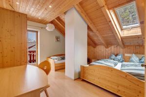 a bedroom in a wooden house with a bed and a table at Ebnichers Paradies in Cardano