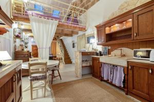 a kitchen with a table and a dining room at Alghero Old Town Gem - Sardinia in Alghero