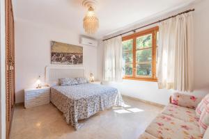 a white bedroom with a bed and a couch at Villa Costa De Blanes in Calvià