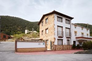 a building with a sign in front of it at Casa Calera in Arbuniel