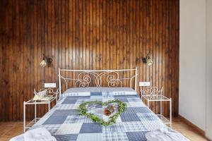 a bedroom with a bed with a heart shapedreath on it at Casa Calera in Arbuniel +23 photos