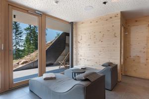 a room with two beds and a large window at Chalet Magdalena und Lodges in Avelengo