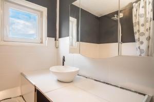 a bathroom with a white sink and a window at Ferienwohnung Idylle in Wasserburg +17 photos