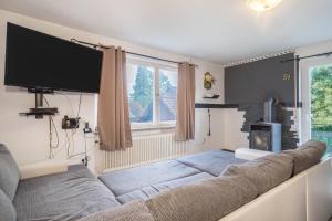 a living room with a couch and a tv at Ferienwohnung Idylle in Wasserburg