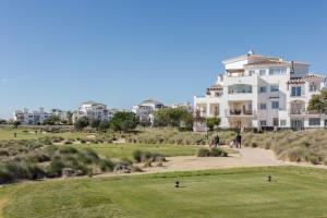 a large white house on a hill with a golf course at Casadeluxe Riquelme in Sucina
