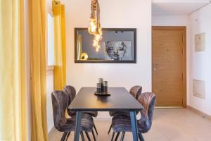 a dining room with a table and chairs at Casadeluxe Riquelme in Sucina