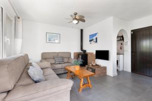 a living room with a couch and a table at La Gardenia 41 in Es Castell