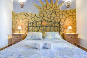 a bedroom with a bed with two pillows on it at Cartuja Rural in Barbate +95 photos