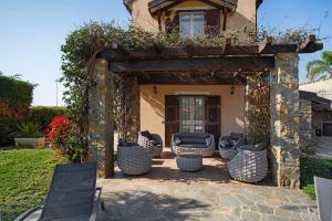a group of chairs sitting on a patio at Villa Vallegrande in Ospedaletti