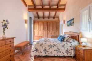 a bedroom with a bed and wooden cabinets at Villa Paqui in Portopetro +22 photos