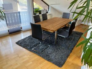 a wooden table and chairs in a living room at Black Forest Brandenkopfblick in Zell am Harmersbach